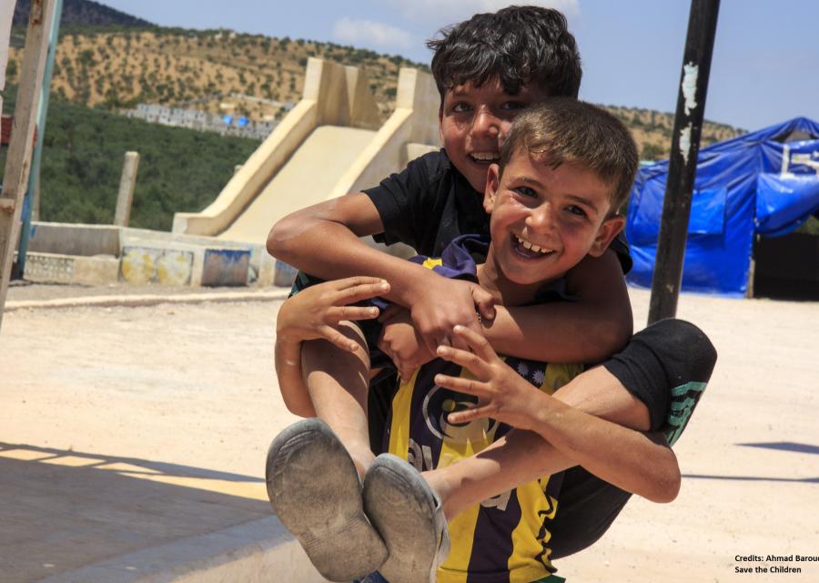 due bambini che giocano insieme uno sulle spalle dell'altro 