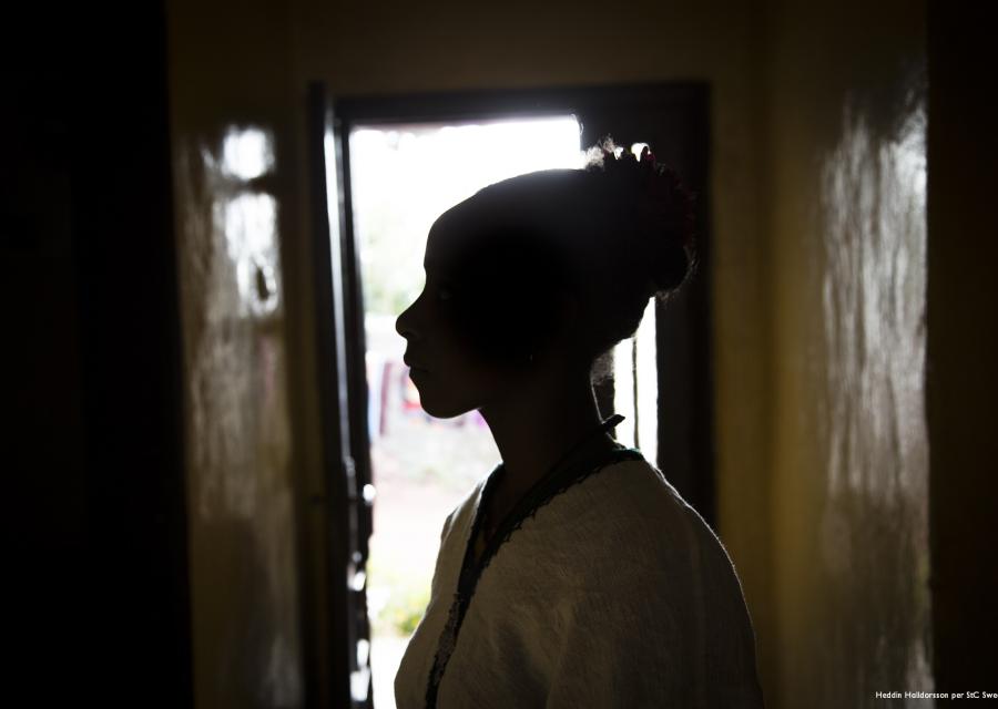 Sagoma ragazza con copricapo in testa foto di profilo in controluce.