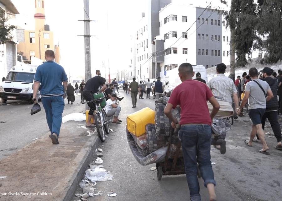 disastro umanitario di Gaza con ragazzo che trasporta barili di acqua