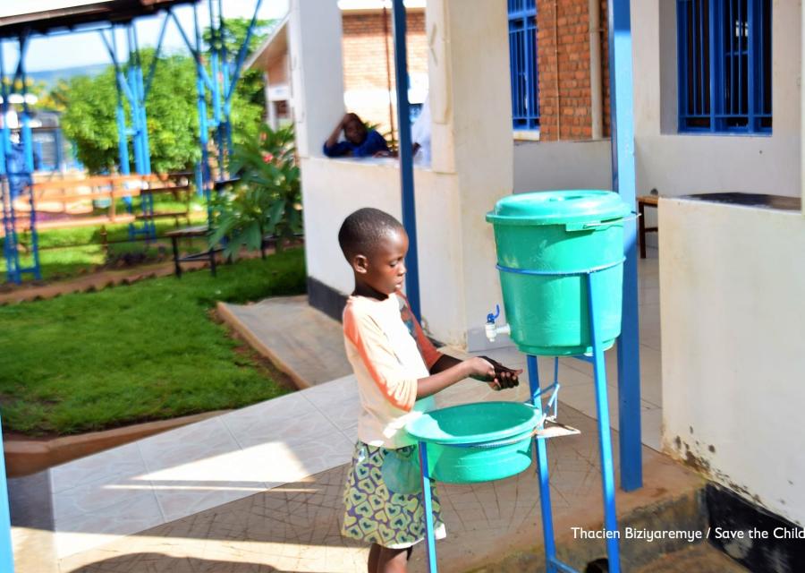 bambina del Rwanda lava le mani con rubinetto portatile