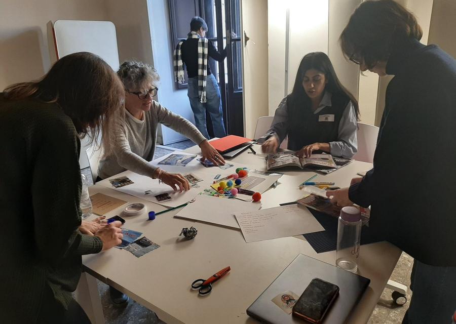 Un gruppo di persone staff save the children lavora insieme appoggiandosi a un tavolo