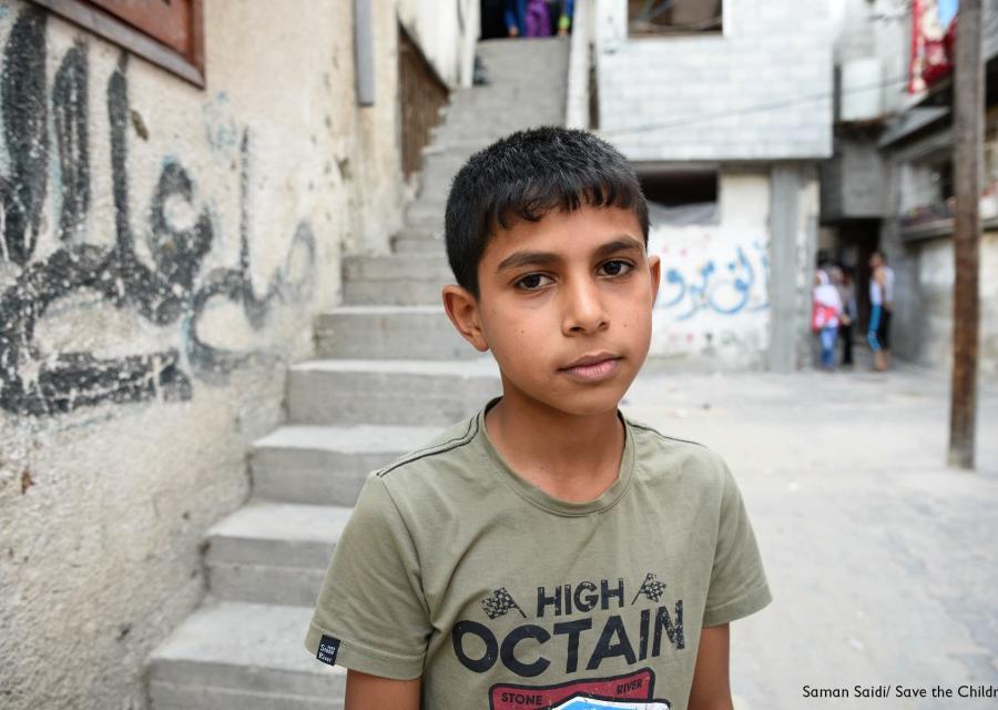 Mezzo busto di un bambino palestinese con maglietta grigia