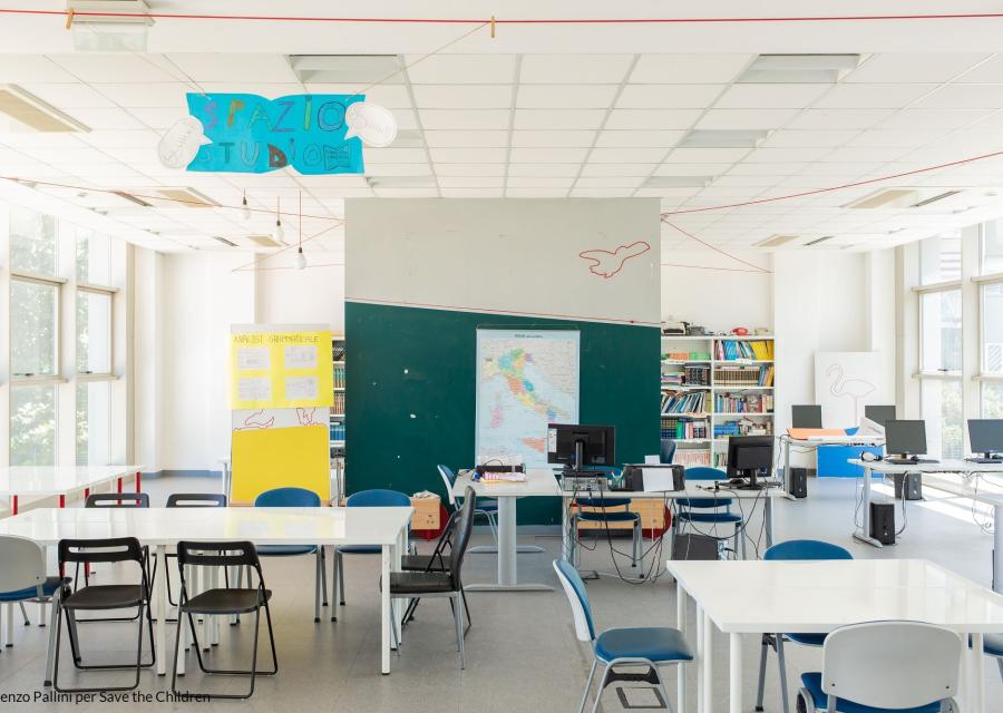 aula studio con banchi e sedie bianchi con lavagna verde, vuota senza bambini e bambine