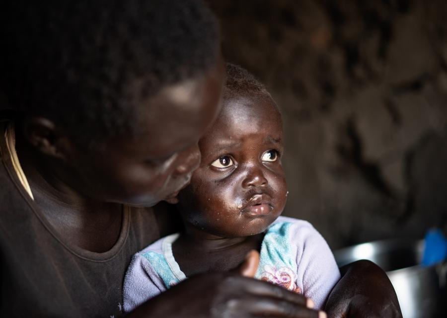 Una bambina di due anni del Sud Sudan con sua madre nel campo rifugiati in Uganda