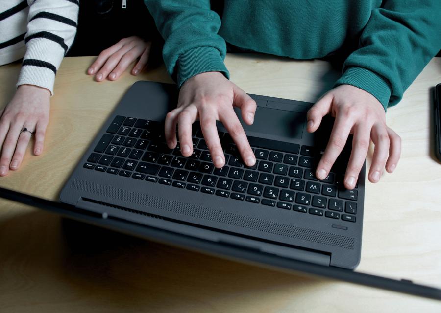 Mani scrittura su un laptop
