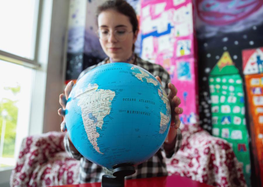 Ragazza che gira un mappamondo